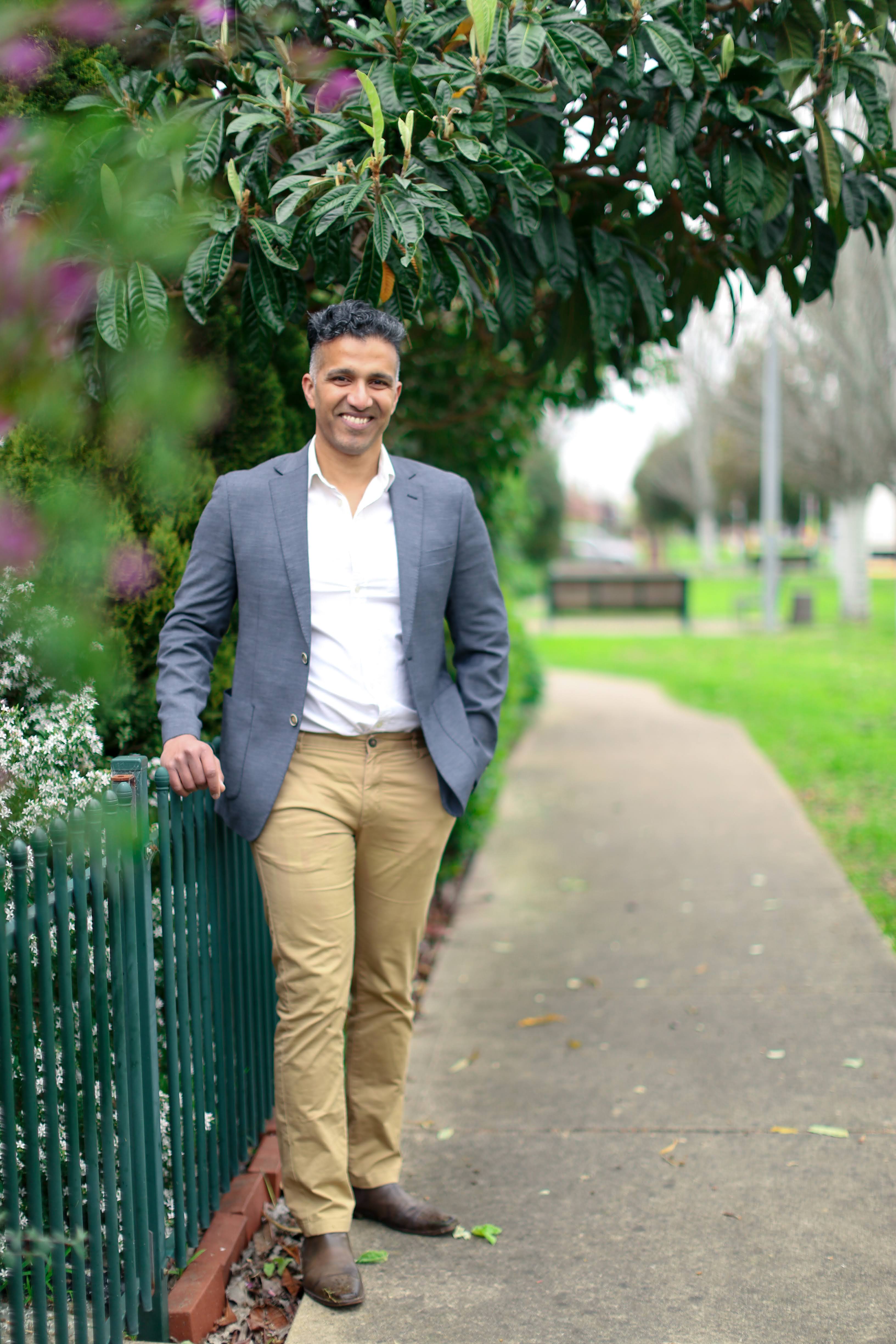 Vinay Nair standing in a park, smiling warmly